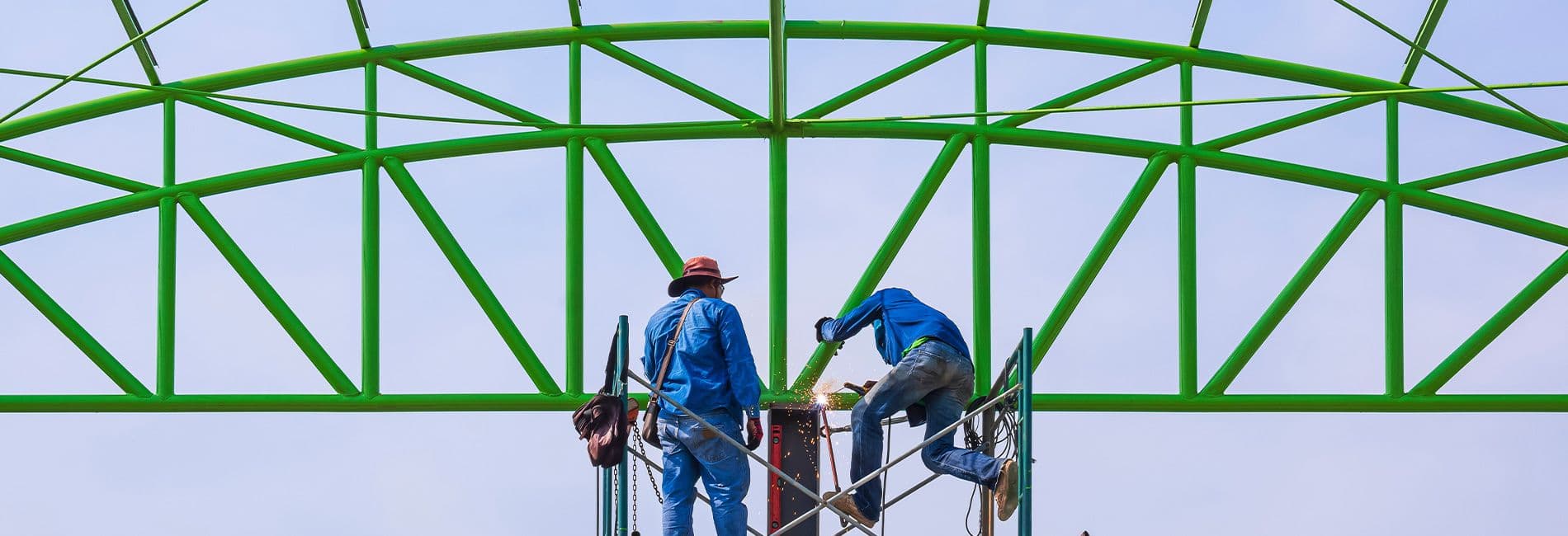 Green powder coated structure being assembled